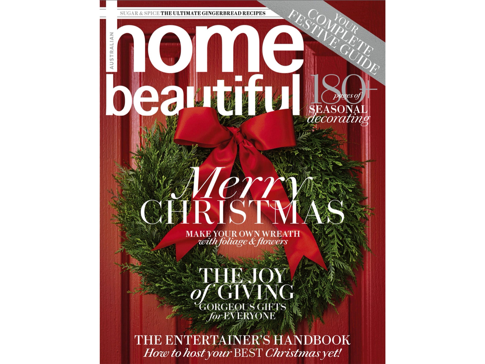 Close up photo of the cover of December 2023 Home Beautiful magazine.  The photo is of a red door with a green wreath with a red bow.